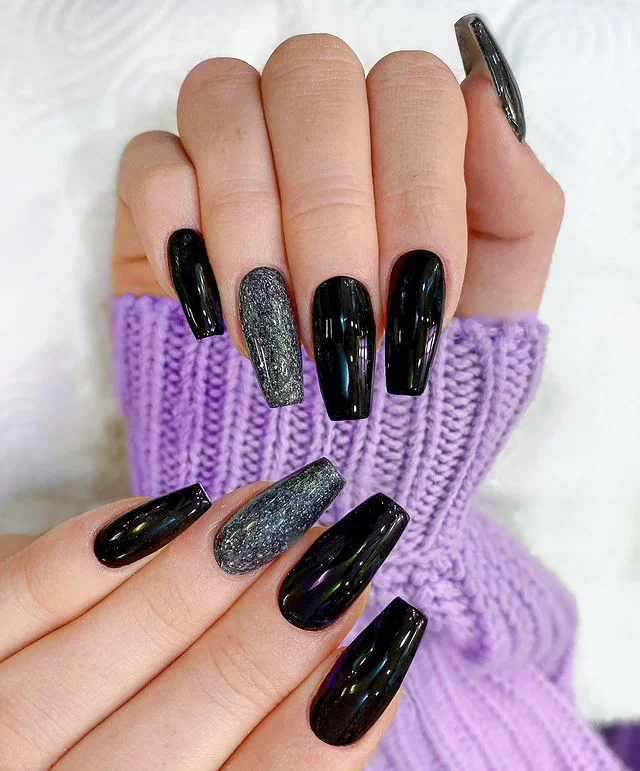 Black glitter nails with gold geometric accents