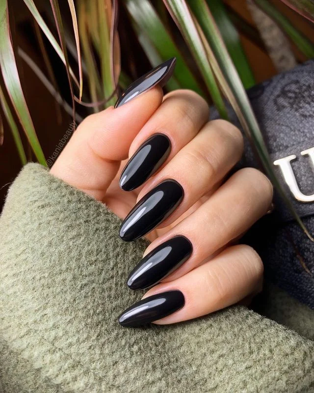 Black nails with delicate gold foil accents