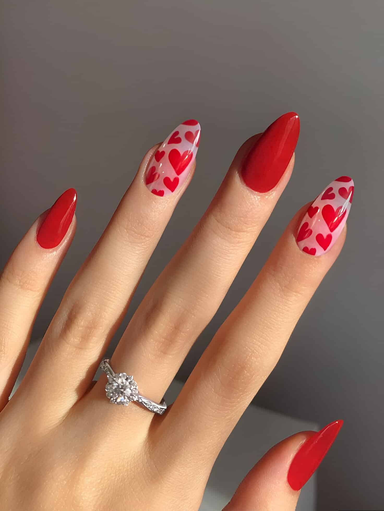 Red ombre Valentine’s Day nails with glitter accents