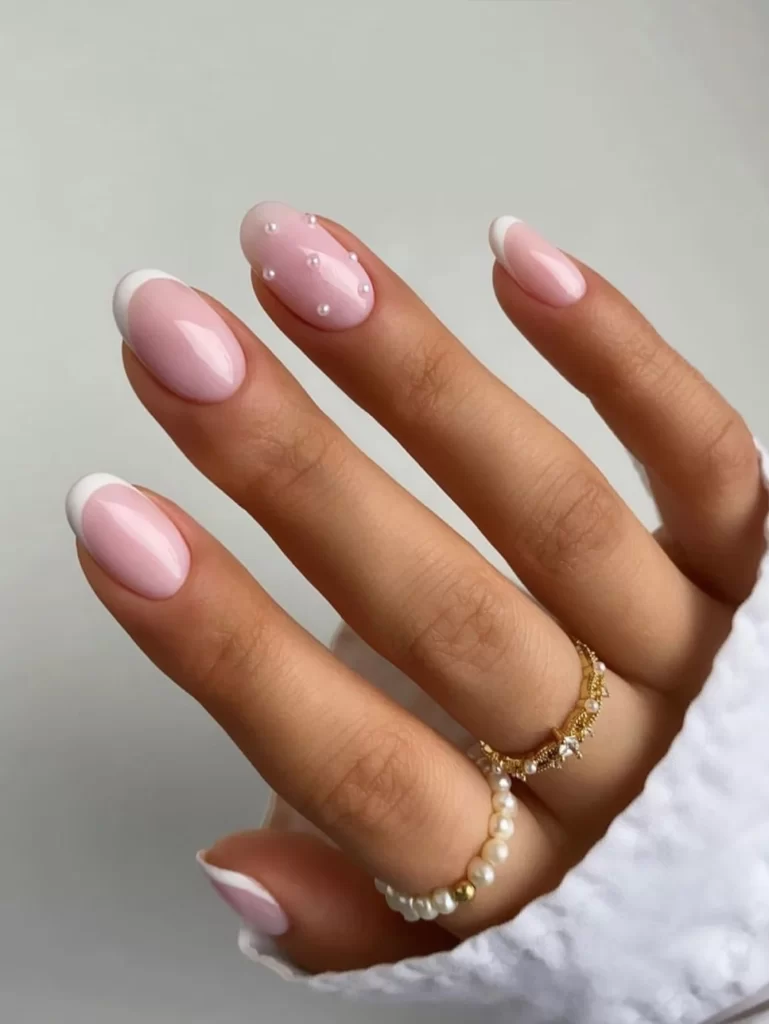 Short acrylic nails with a modernized French manicure featuring thinner white tips