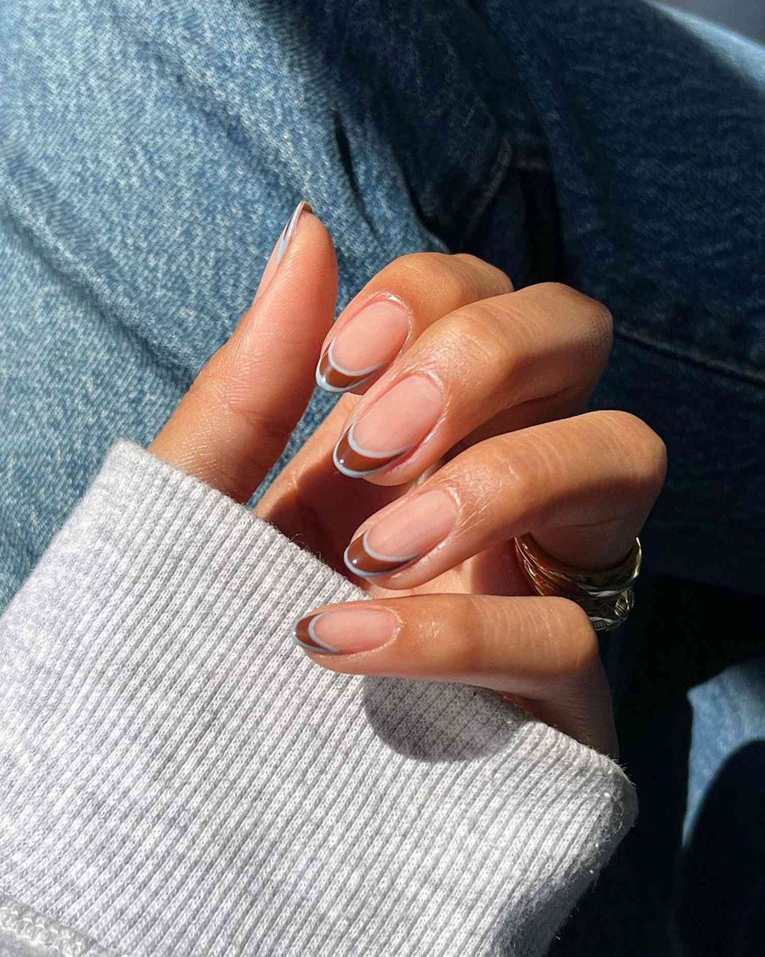 Glossy cherry-red Valentine’s nails with heart detailing on accent nails