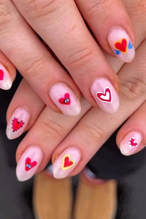 French ombré Valentine’s nails with white tips and tiny red hearts