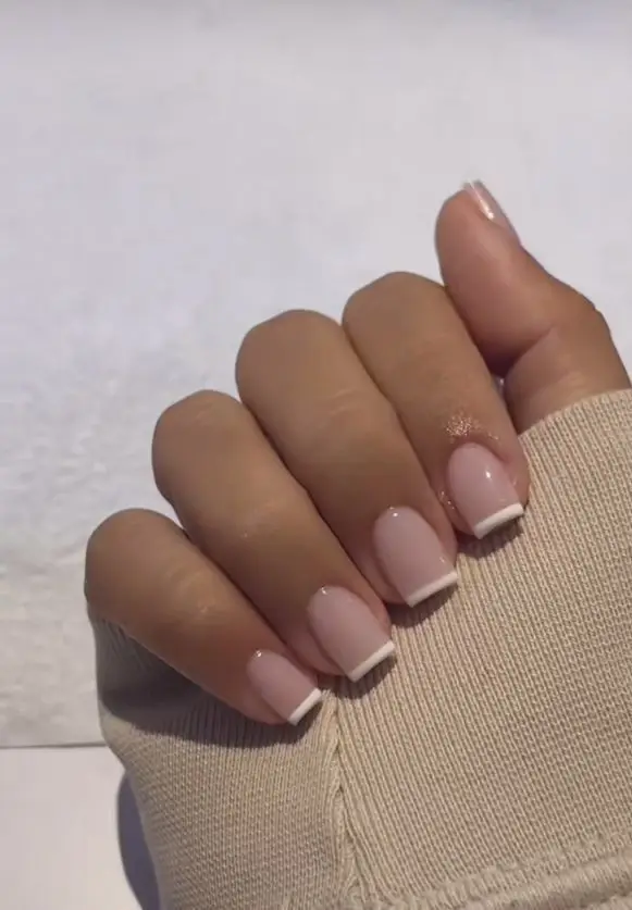 Short acrylic nails in a soft lavender shade with a satin-like finish