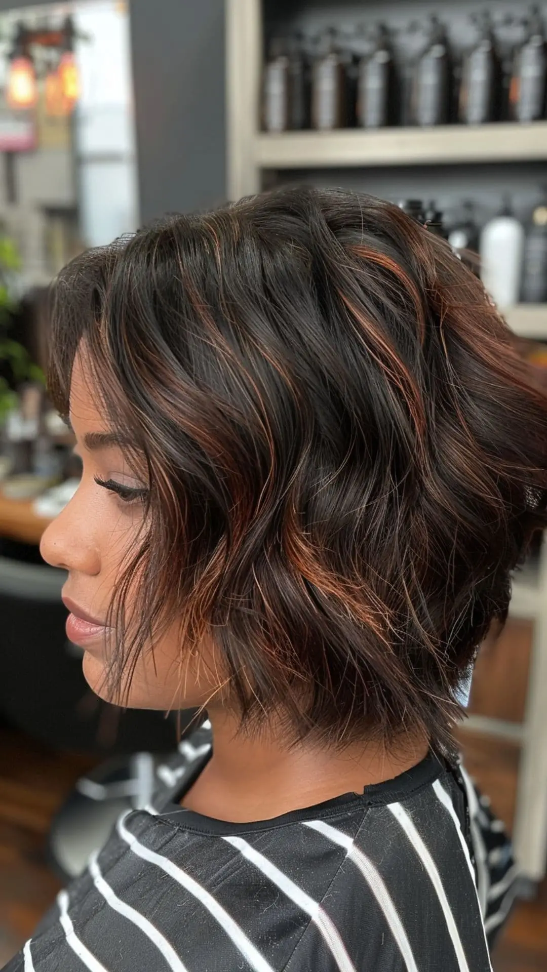 Dark brown hair with luscious auburn highlights creating a warm, radiant look