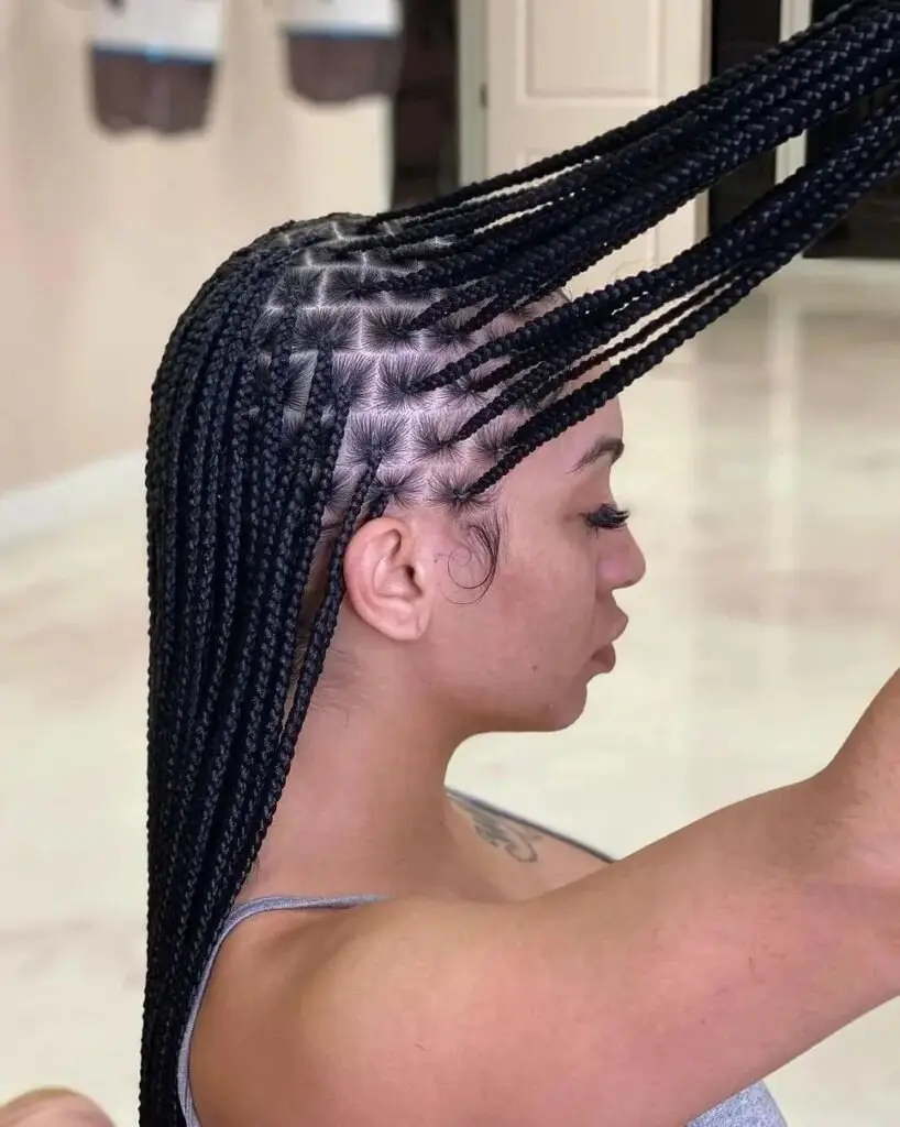 Angled feed-in goddess cornrows framing the face and extending into intricate braids